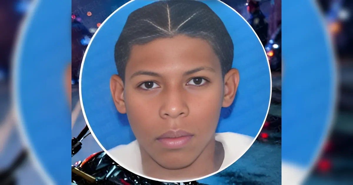 Portrait of a young boy with short dark hair against a blue oval frame.
