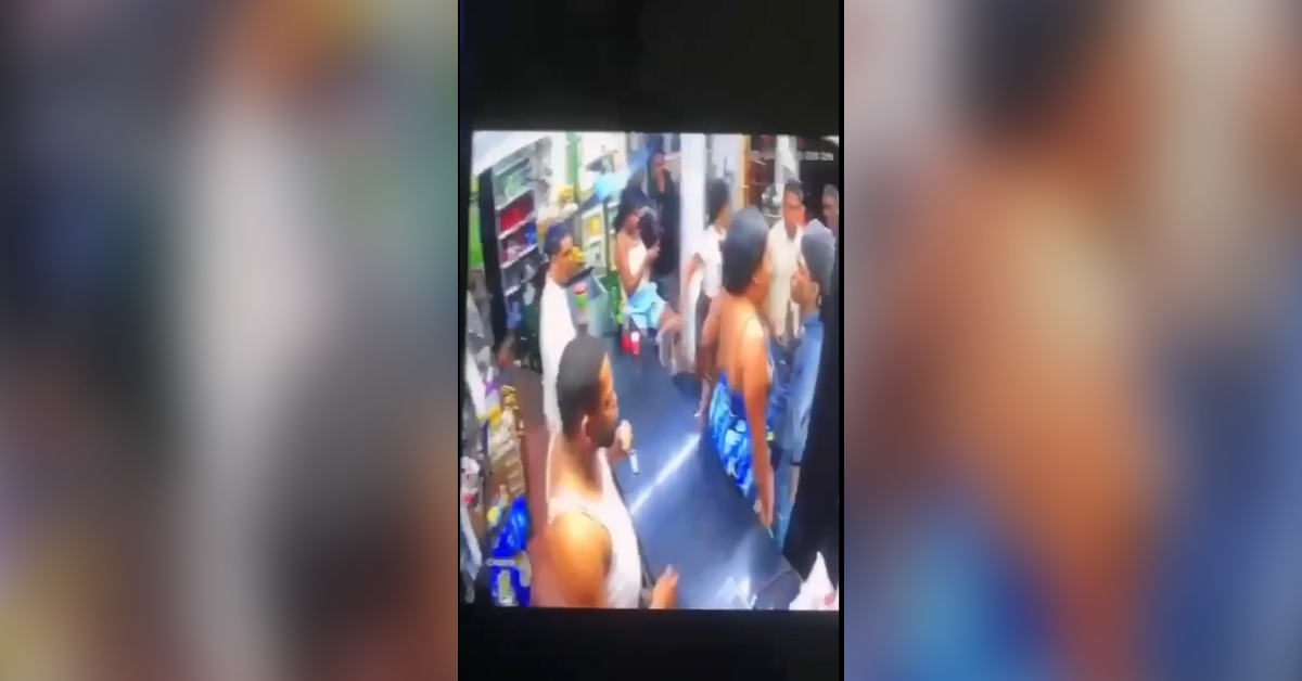 Crowded convenience store interior with customers gathered near shelves and counters.