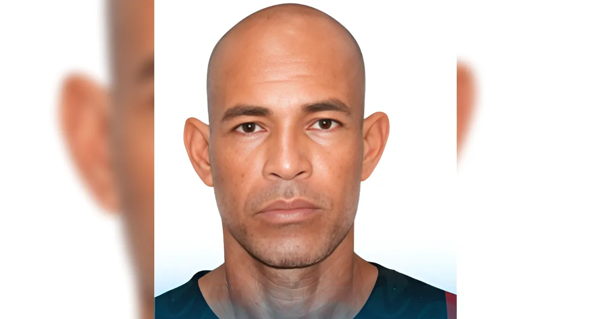 Head-and-shoulders portrait of a bald man with a neutral expression against a light background.