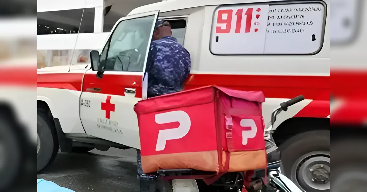 Paramedic in camouflage uniform beside an ambulance with 911 on the side; a red delivery bag sits on a motorcycle in the foreground.