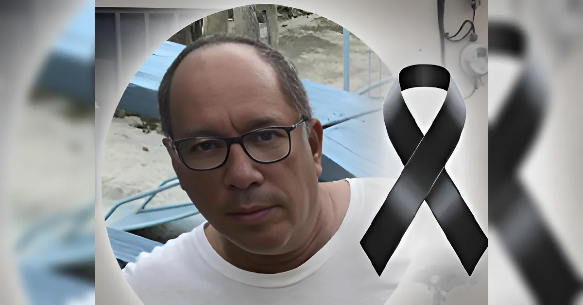 Portrait of a man with glasses in a white shirt, circular frame, black mourning ribbon overlay indicating tribute.