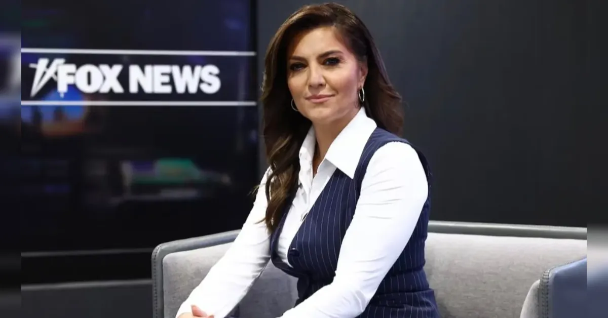 News anchor seated on a grey sofa in a Fox News studio with the logo visible in the background.