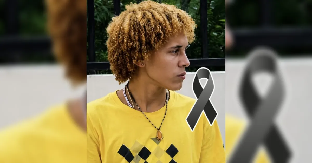 Profile view of a young person with curly blond hair wearing a yellow shirt; a gray awareness ribbon overlays the image.