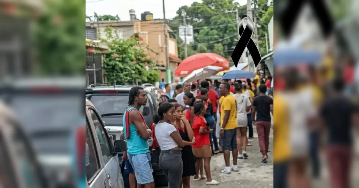 Crowd of people lined up along a street with parked cars and market stalls with umbrellas, a mourning ribbon overlaid in the corner.
