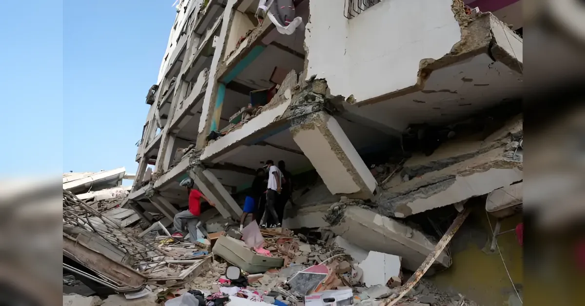 People search through rubble at a collapsed multi-story building with exposed concrete and debris around them