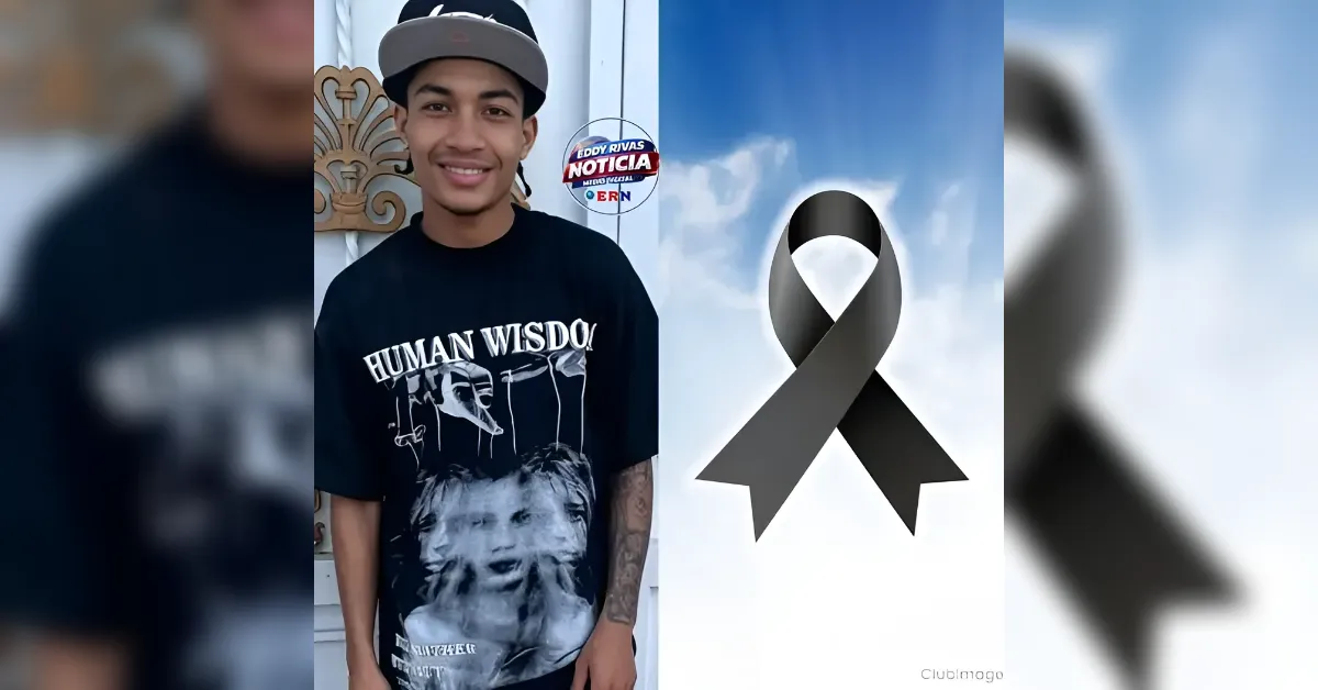 Young man in a black graphic t‑shirt and gray cap smiling outdoors, with a large black awareness ribbon overlay on a blue sky background.