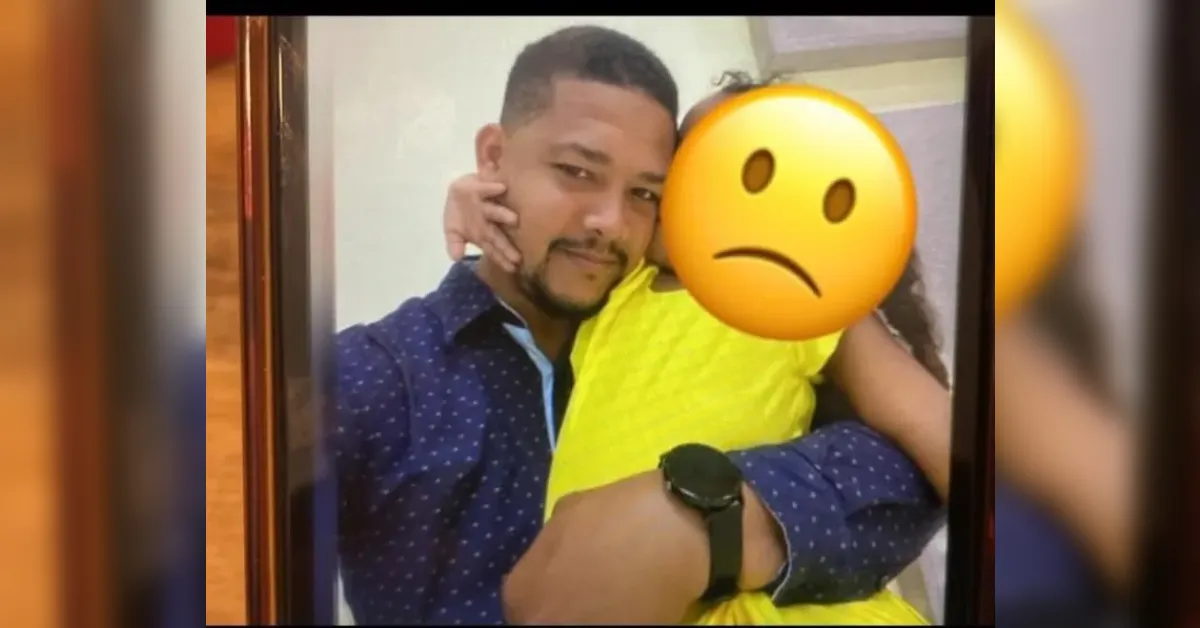 Man in a blue dotted shirt hugs a person in a bright yellow garment; a large sad emoji covers the other person's face.