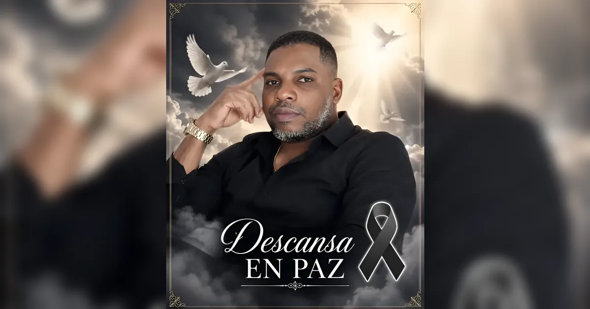 Memorial poster featuring a man in a black shirt, with doves and clouds in a decorative frame, text 'Descansa En Paz' and a black ribbon.