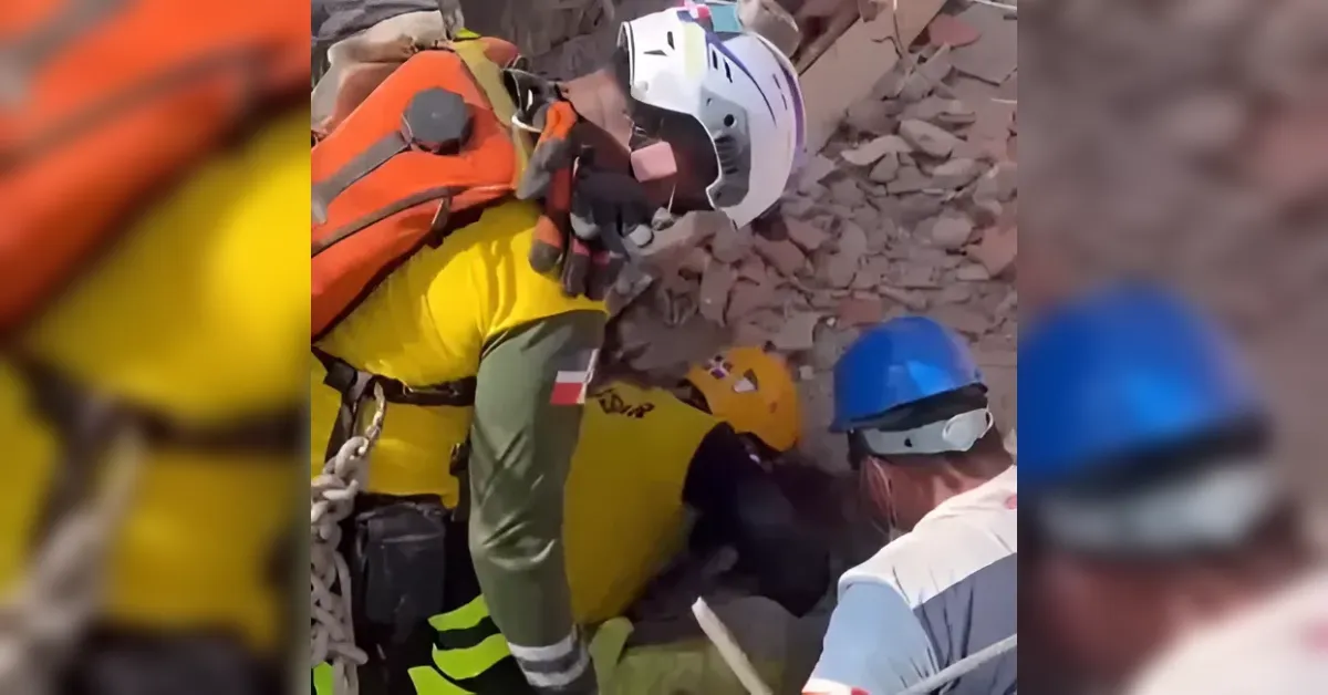 Rescue workers in helmets and high-visibility clothing search through rubble at a collapsed structure.