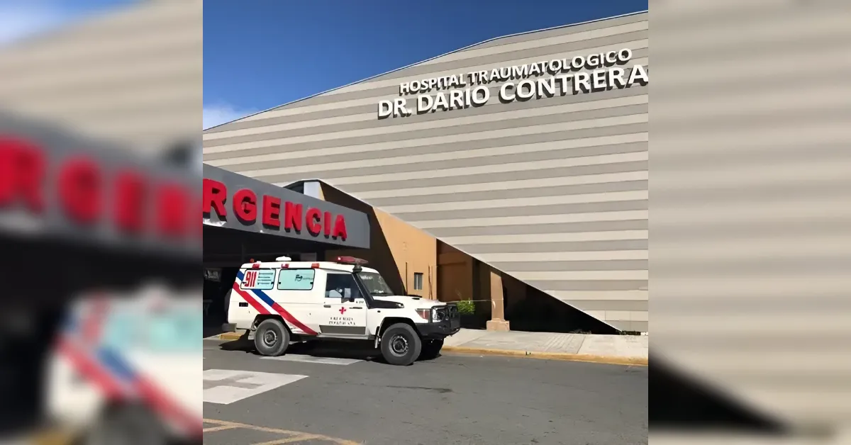 Ambulance parked at the emergency entrance of Hospital Traumatologico Dr. Darío Contreras; urgency sign visible in red lettering.