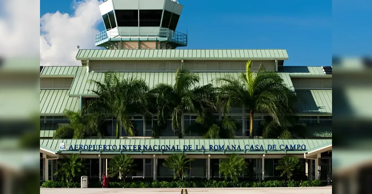 Front view of La Romana International Airport (Casa de Campo) terminal with palm trees in front.