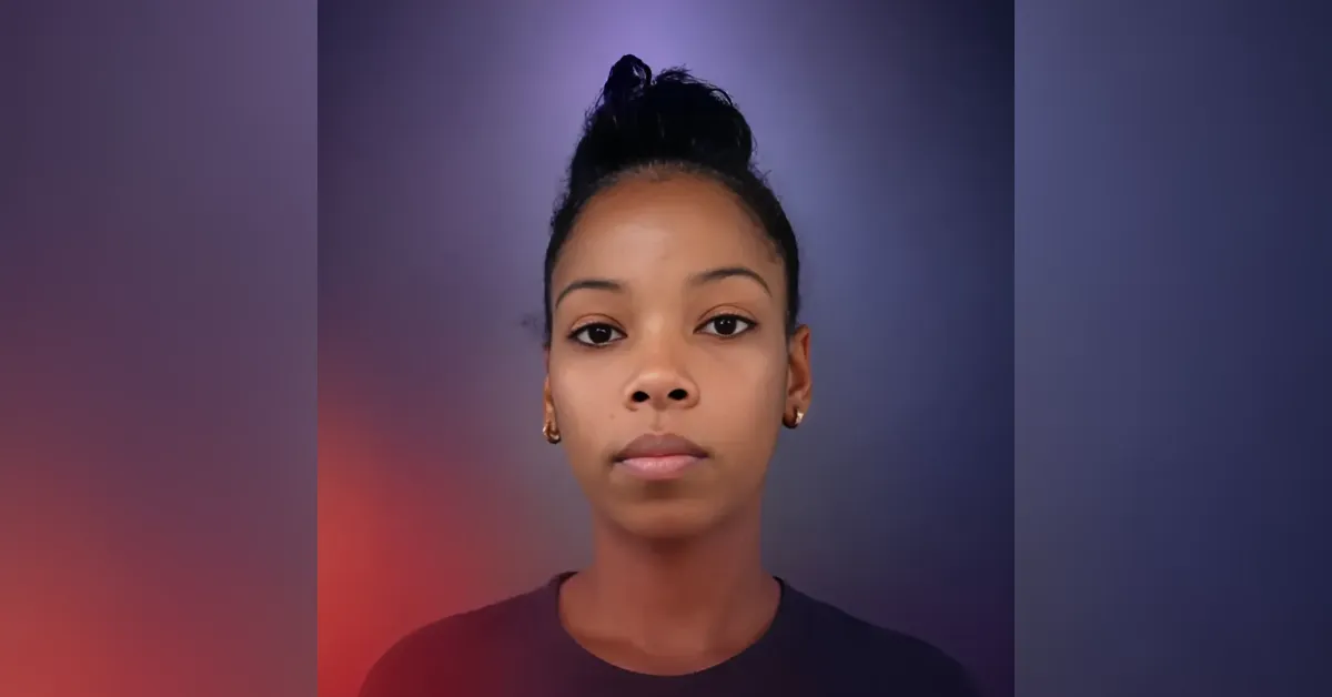 Young woman faces the camera with a neutral expression against a purple-to-orange gradient backdrop.