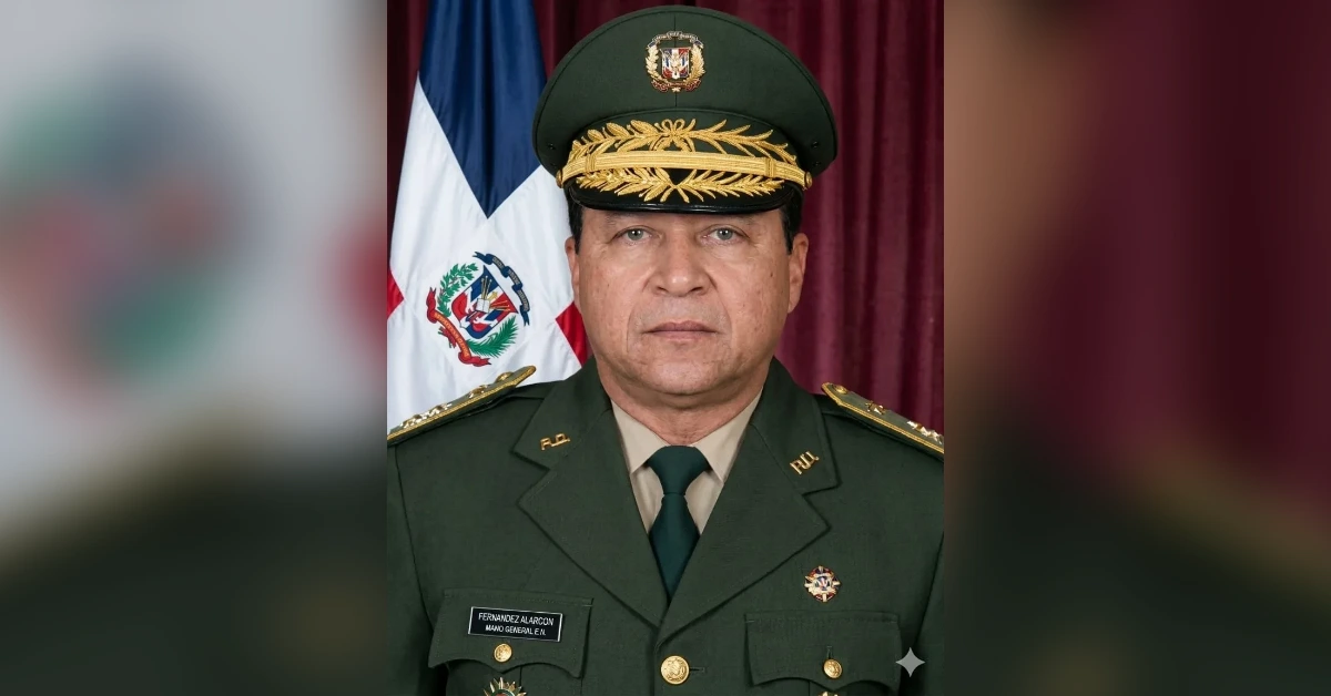 High-ranking military officer in a dark green uniform and peaked cap, posed in front of a Dominican flag behind him.