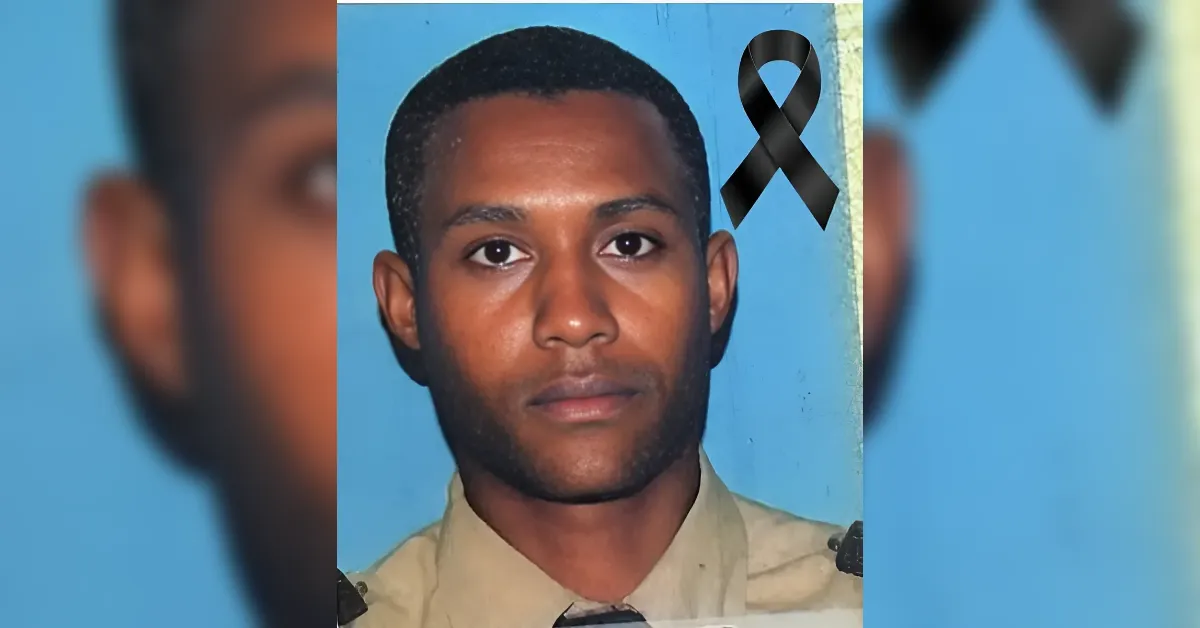 Portrait of a young man in uniform against a blue background with a black mourning ribbon, used as a memorial image.