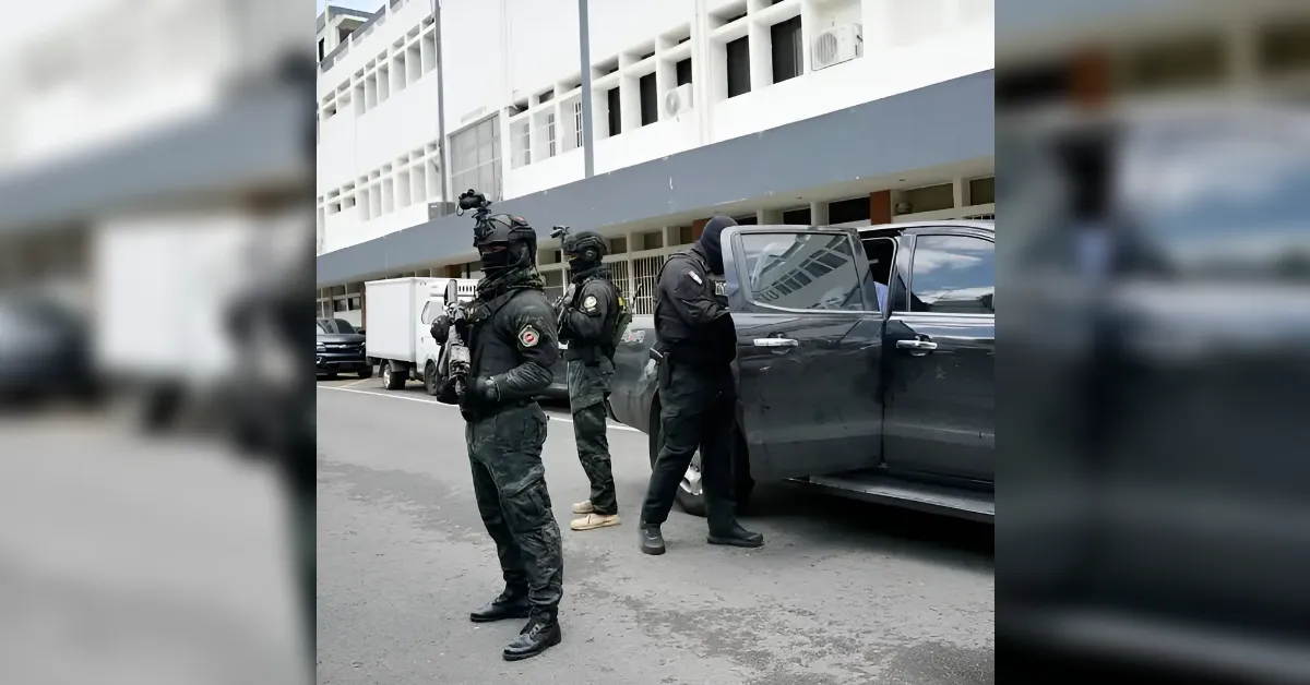 Tactical police officers in black gear and helmets stand beside a dark pickup with its door open on an urban street.
