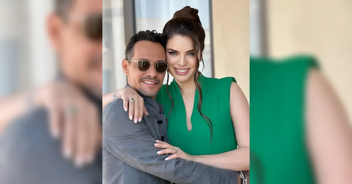 Couple posing together outdoors, the woman in a green sleeveless dress leaning on a man wearing sunglasses.