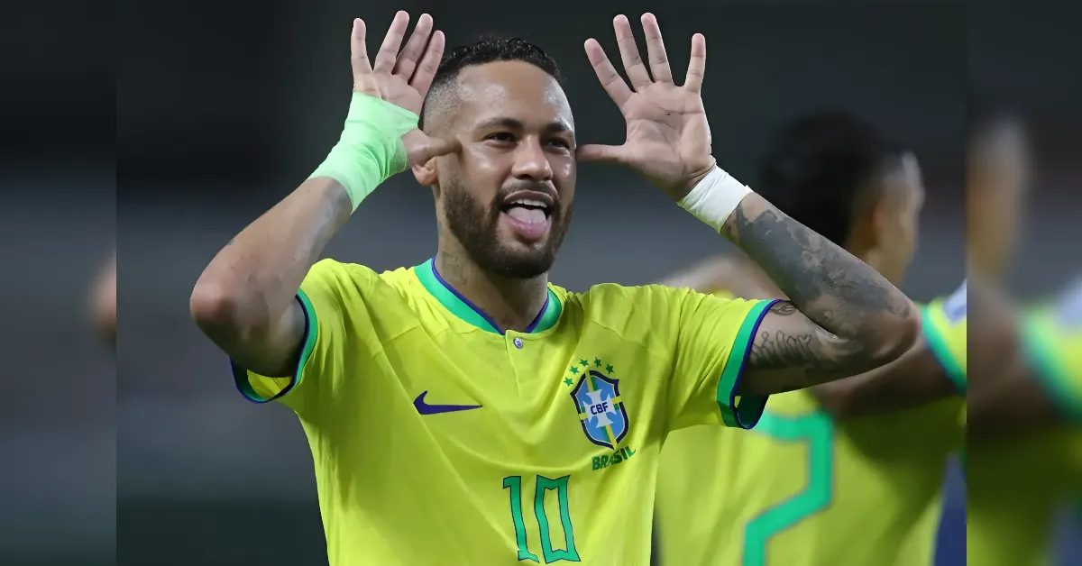 Footballer in Brazil yellow kit (#10) celebrates with hands raised to ears.