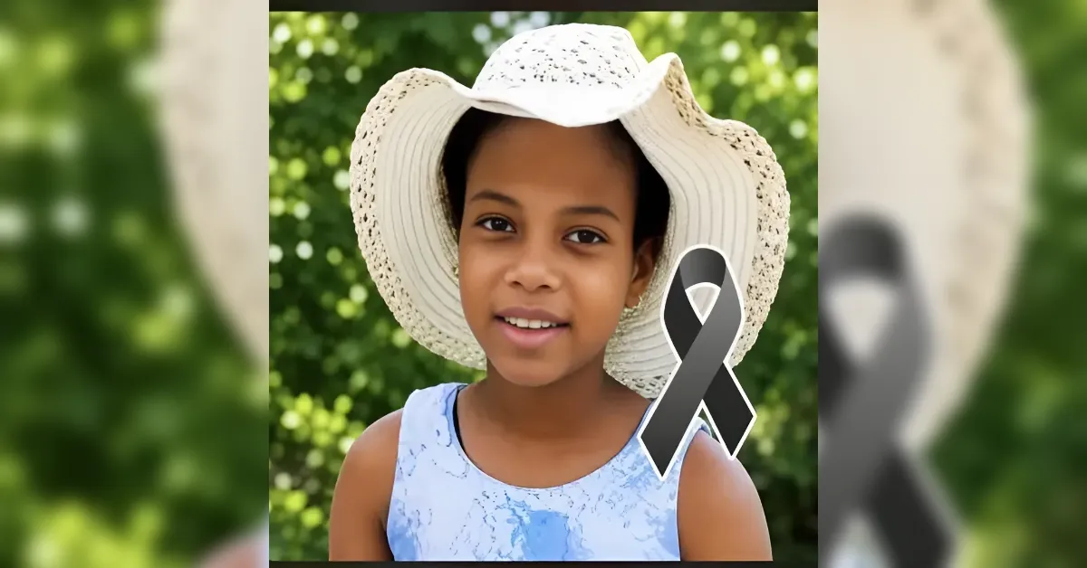 Girl wearing a wide-brimmed hat outdoors with a black awareness ribbon. (Awareness/Remembrance theme)