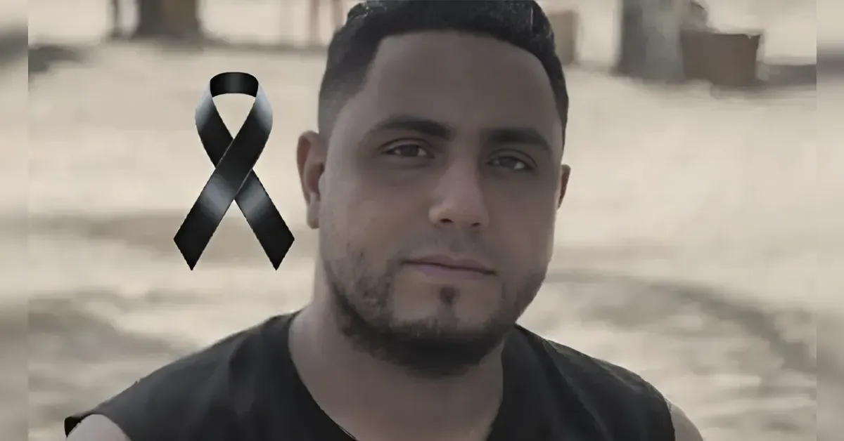 Portrait of a man outdoors with a black mourning ribbon overlaid, signaling loss or tribute