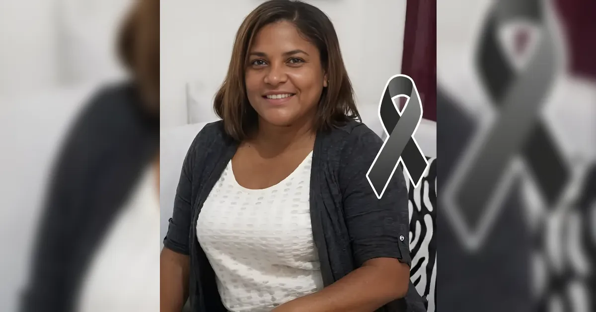 Smiling woman seated indoors in a white top and dark cardigan, with a gray awareness ribbon graphic beside her.