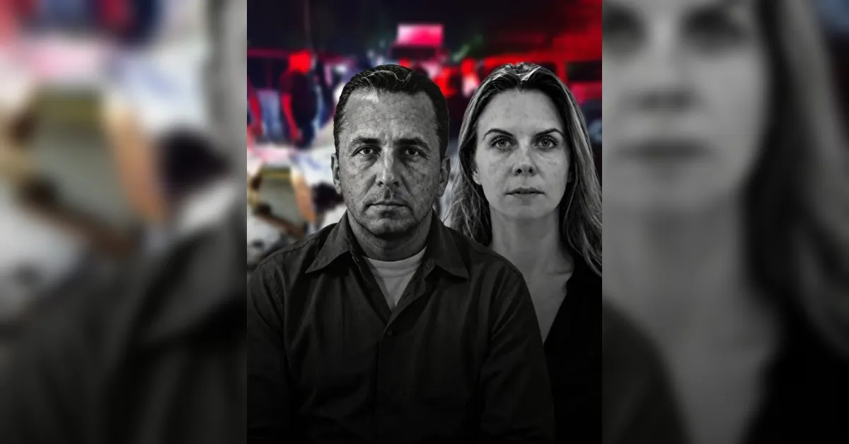 Two adults, a man and a woman, with serious expressions, sit side by side in the foreground as a blurred crowd and red lights appear in the background.