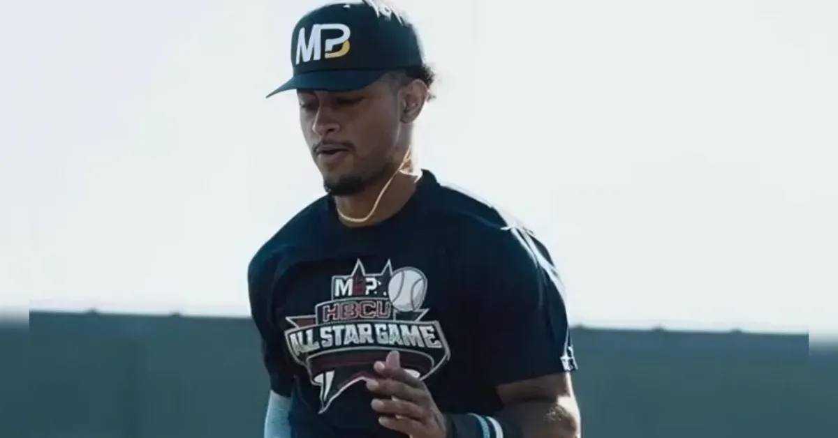 Athlete wearing a black MP cap and an All-Star Game shirt, running outdoors. The shirt reads ALL-STAR GAME with a basketball graphic.