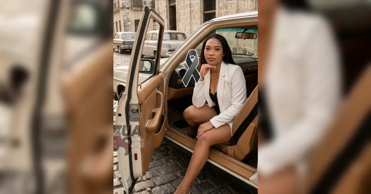 Woman in a white blazer sits in the open door of a tan car, resting her chin on her hand on a cobblestone street.