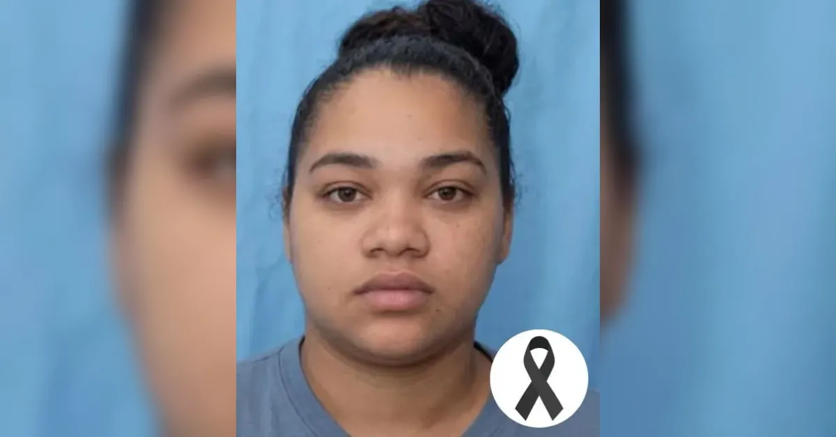 Portrait of a woman with a neutral expression against a blue background, a white circle with a black awareness ribbon overlays the corner.