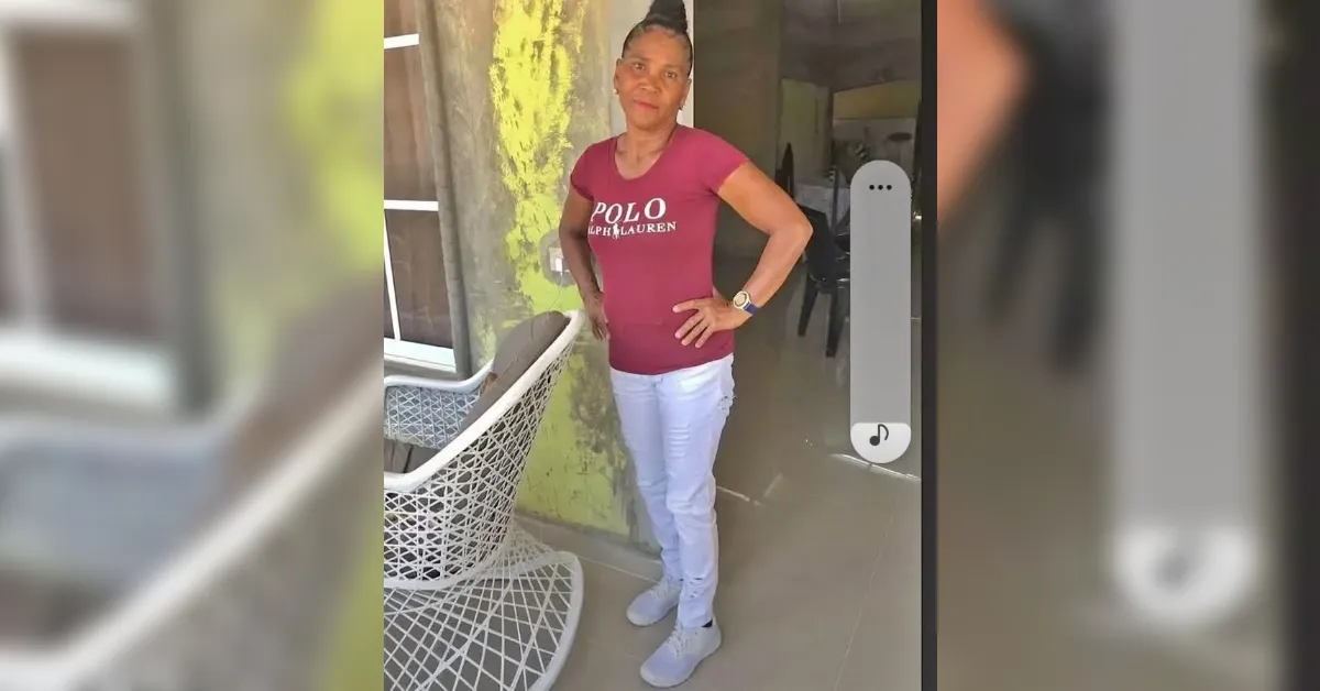 Woman posing with hands on hips outside a building, wearing a maroon Polo Ralph Lauren T-shirt and light pants.