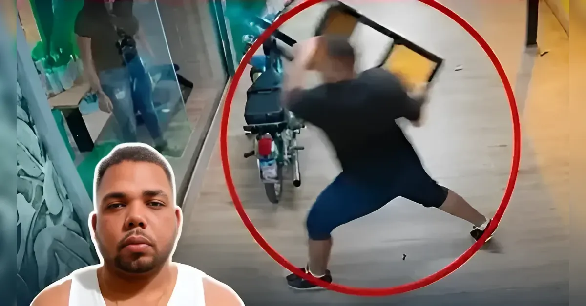 Man in black shirt swinging a tablet at a parked scooter in a mall, circled in red.