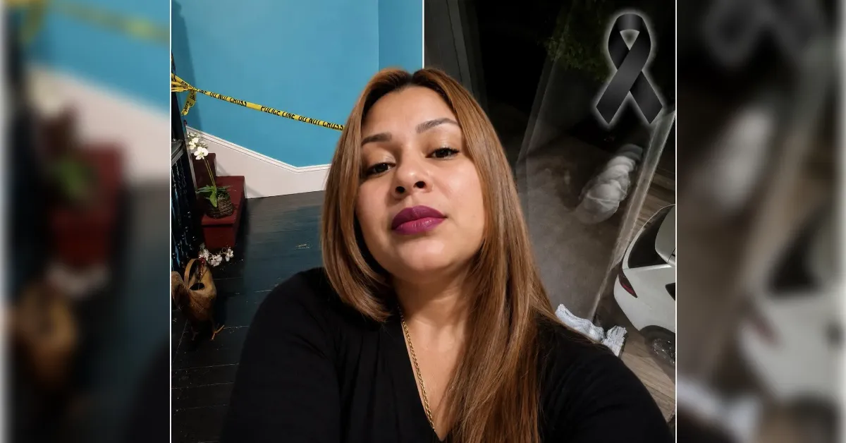 Selfie of a woman with light brown hair wearing a black top; teal wall, stairs, plants, and a parked car visible in the background. A black memorial ribbon appears on the right side.