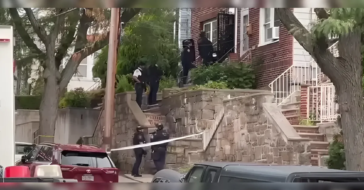 Police officers stand on a stone staircase behind white crime-scene tape in a residential neighborhood.