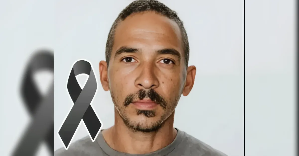 Portrait of a man with a gray/black awareness ribbon overlaid, symbolizing remembrance or support.