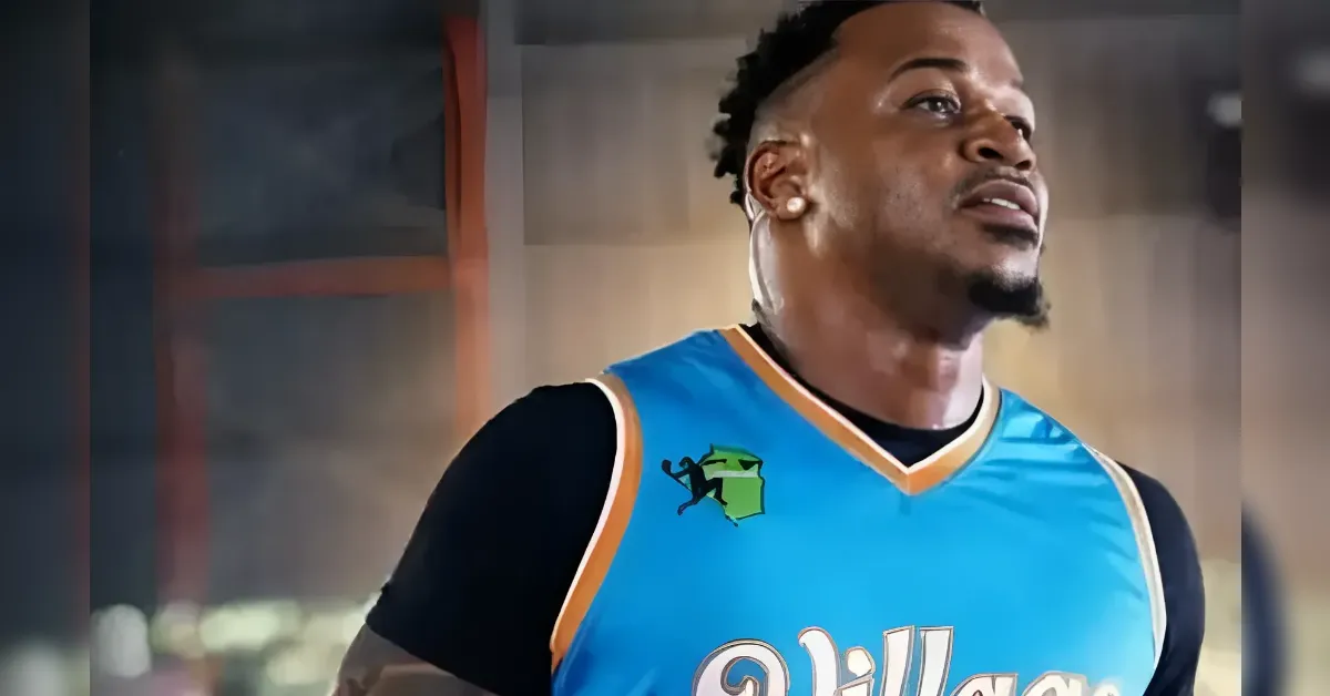 Athlete in a blue basketball jersey looking up, indoors.