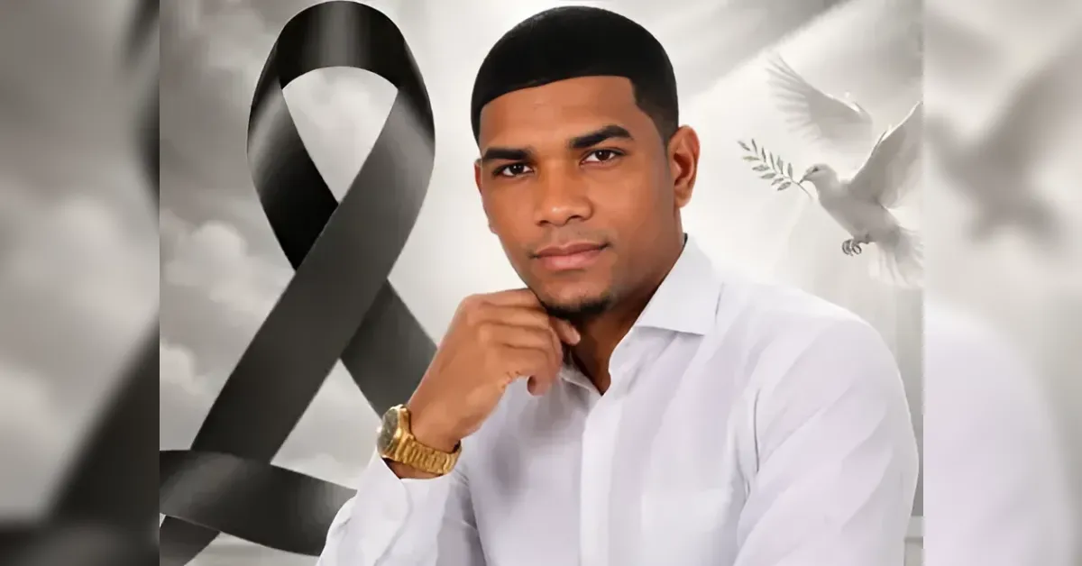 Portrait of a man in a white shirt with a gold watch, set against a memorial background featuring a large black mourning ribbon and a dove.