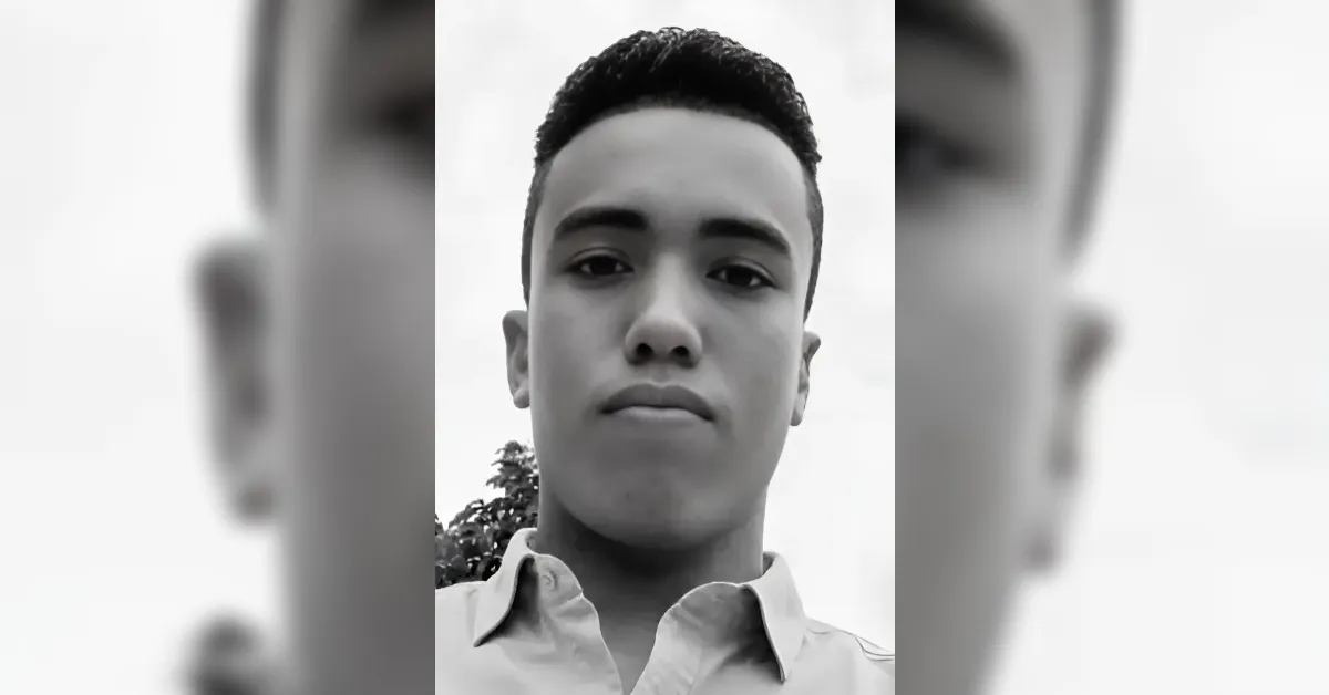 Black-and-white close-up portrait of a young man looking straight at the camera.