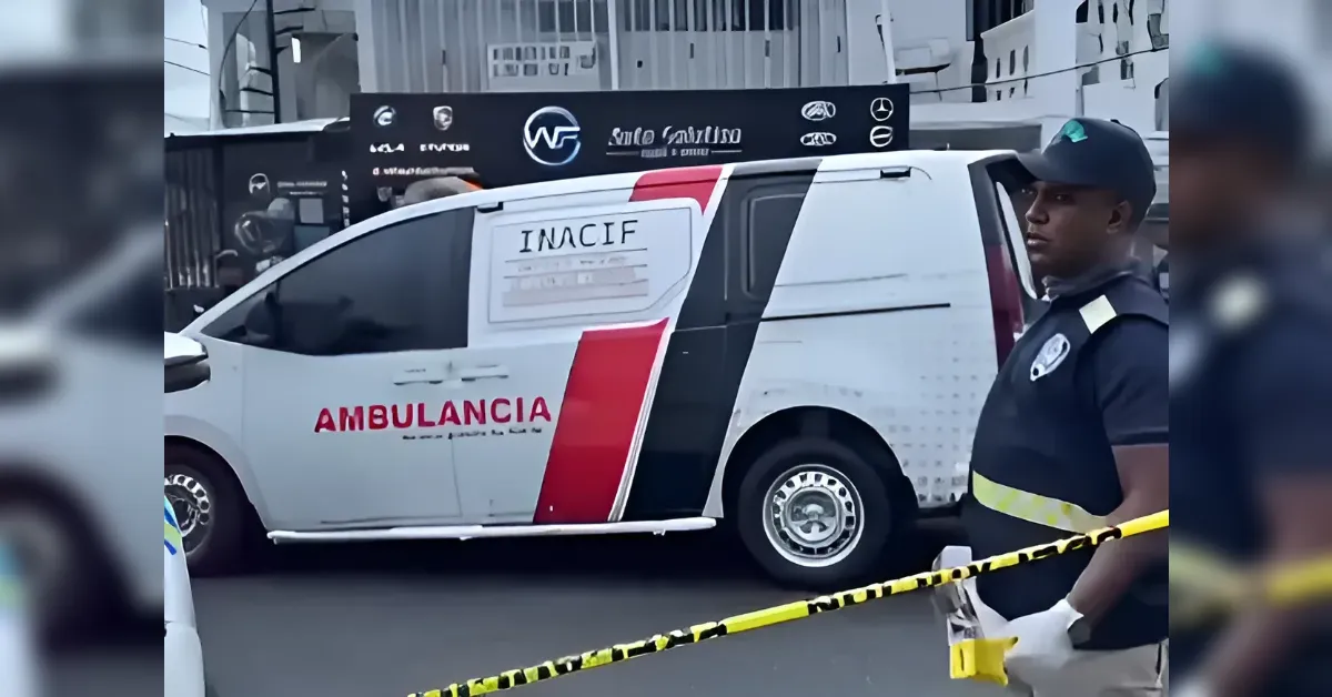 White ambulance with red stripe and 'AMBULANCIA' text parked on the street; police tape in foreground and a uniformed officer nearby.
