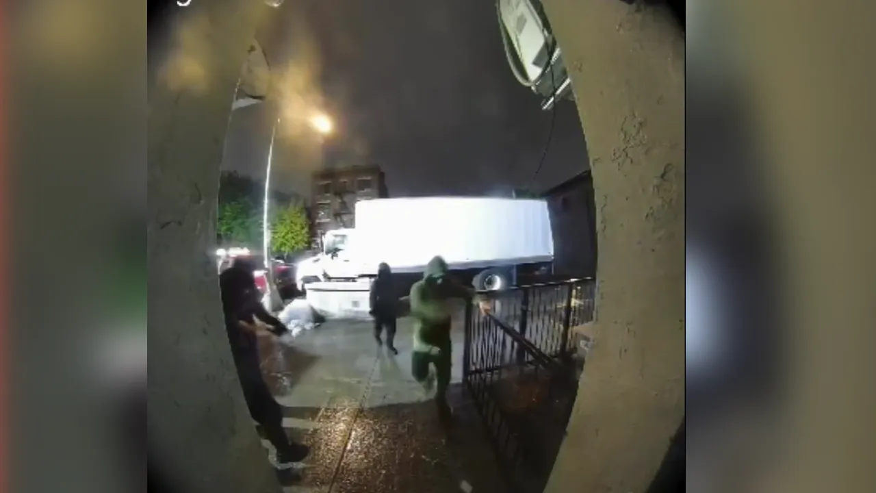Nighttime street scene: a person in green runs toward a gate while a large white truck sits in the background.
