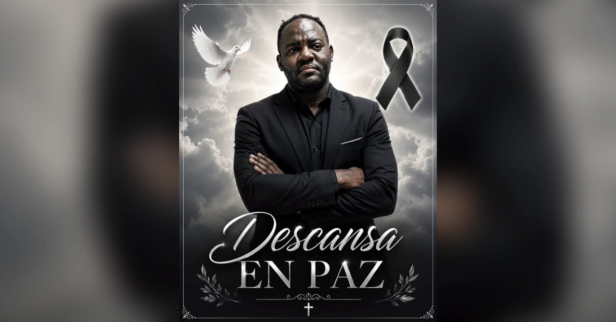 Memorial poster: man in a dark suit with arms crossed, a dove, black ribbon, and 'Descansa en Paz' over a cloudy sky.