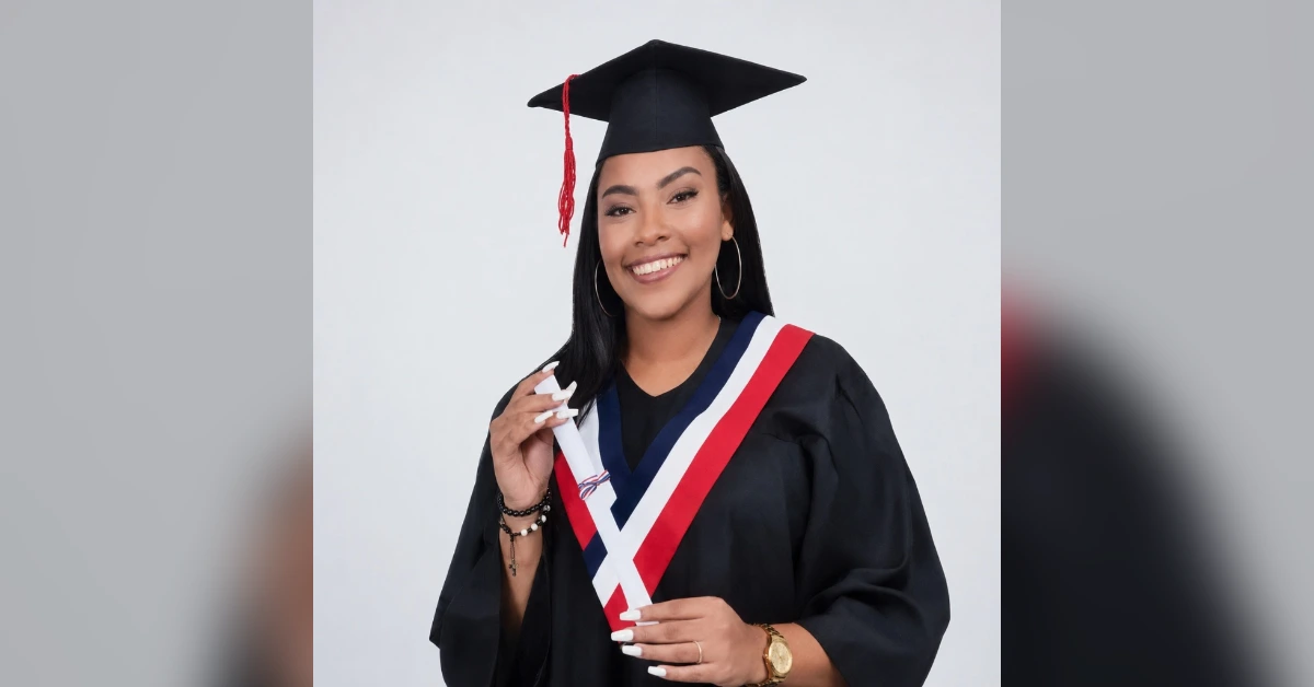 Young woman in a black graduation gown and cap, smiling while holding her diploma.