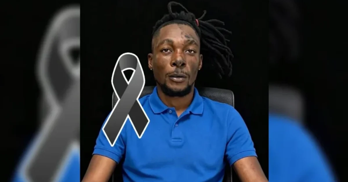 A man wearing a blue polo shirt sits against a dark background with a large black awareness ribbon overlayed on his chest, signaling mourning or support.