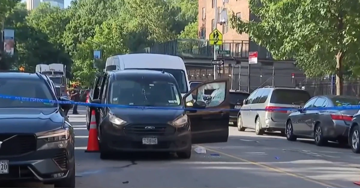 Black van with its driver-side door open on a city street, orange traffic cone nearby, police tape across the road suggesting a secured scene.