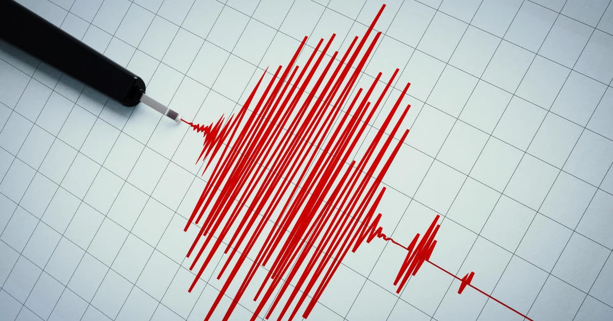 Red jagged data line traced by a pen on a gridded chart, resembling an ECG or data trace.