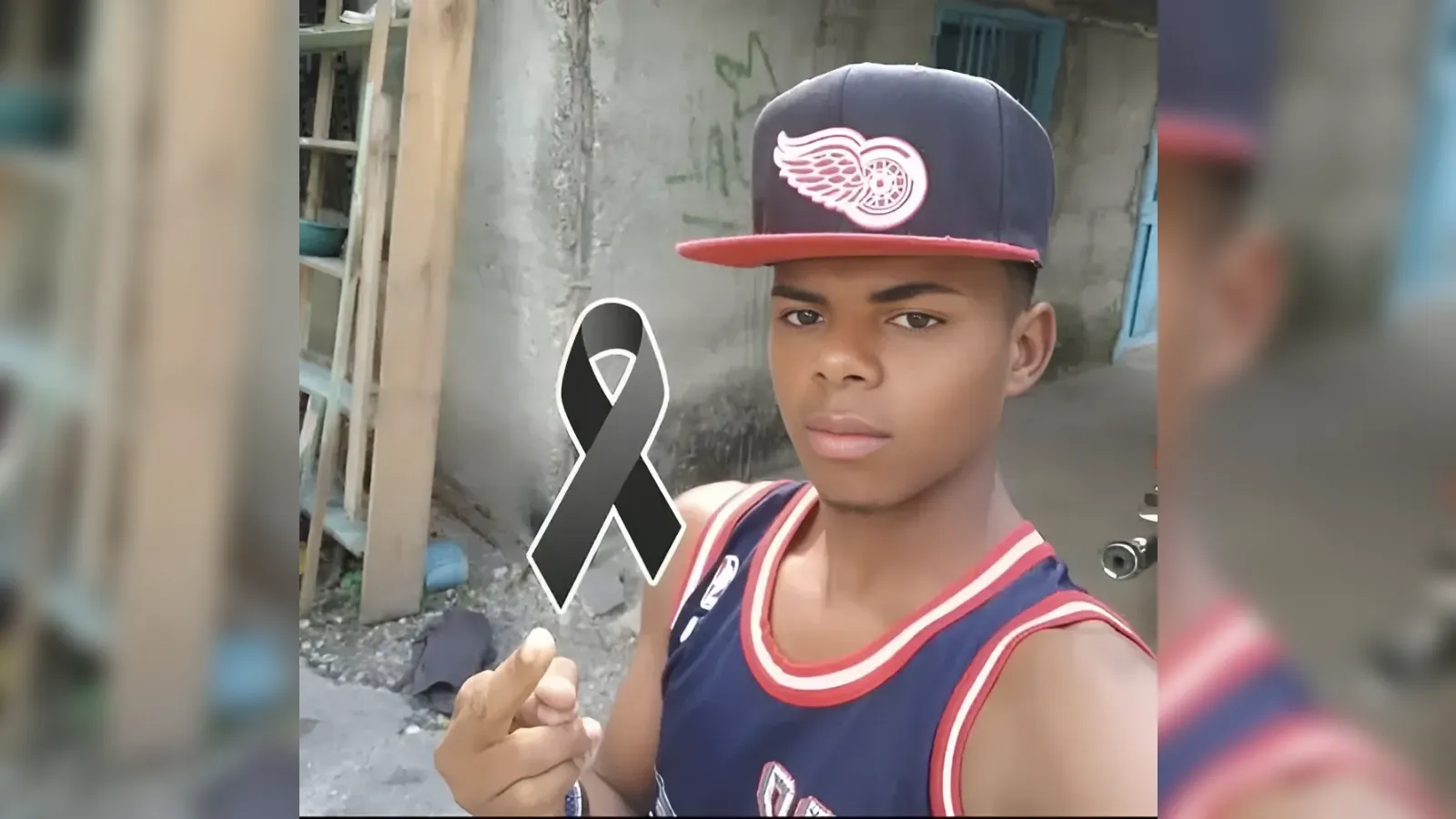 Selfie of a teenage boy in a sleeveless jersey and cap, standing in an alley with a large black mourning ribbon graphic overlaying the image.