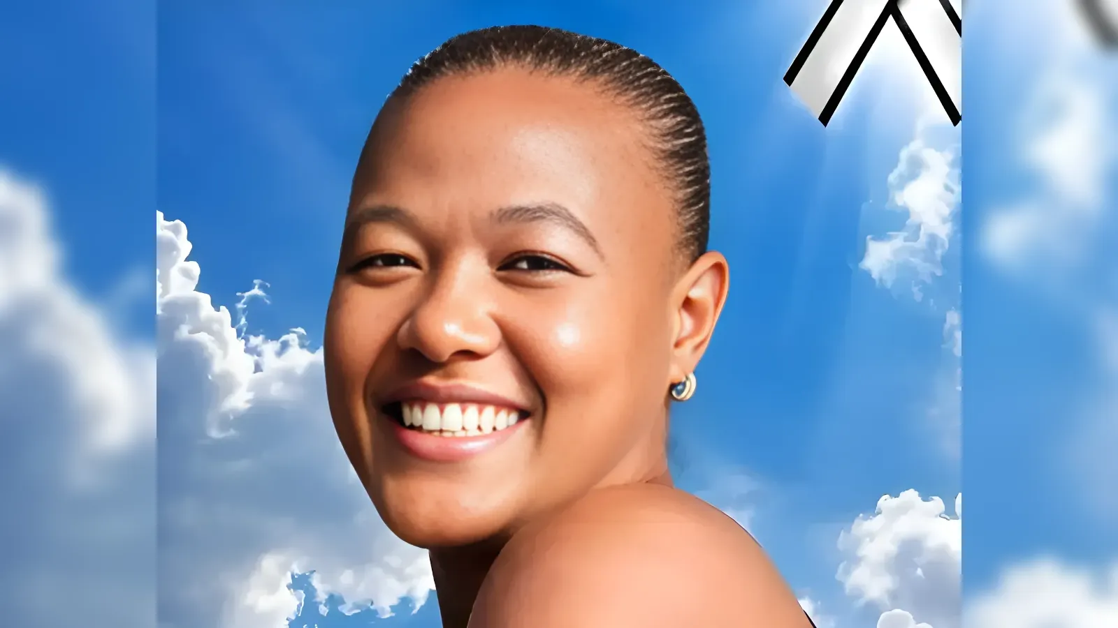 Smiling person with short hair and hoop earring, against a blue sky with clouds; black-and-white ribbon in the corner.