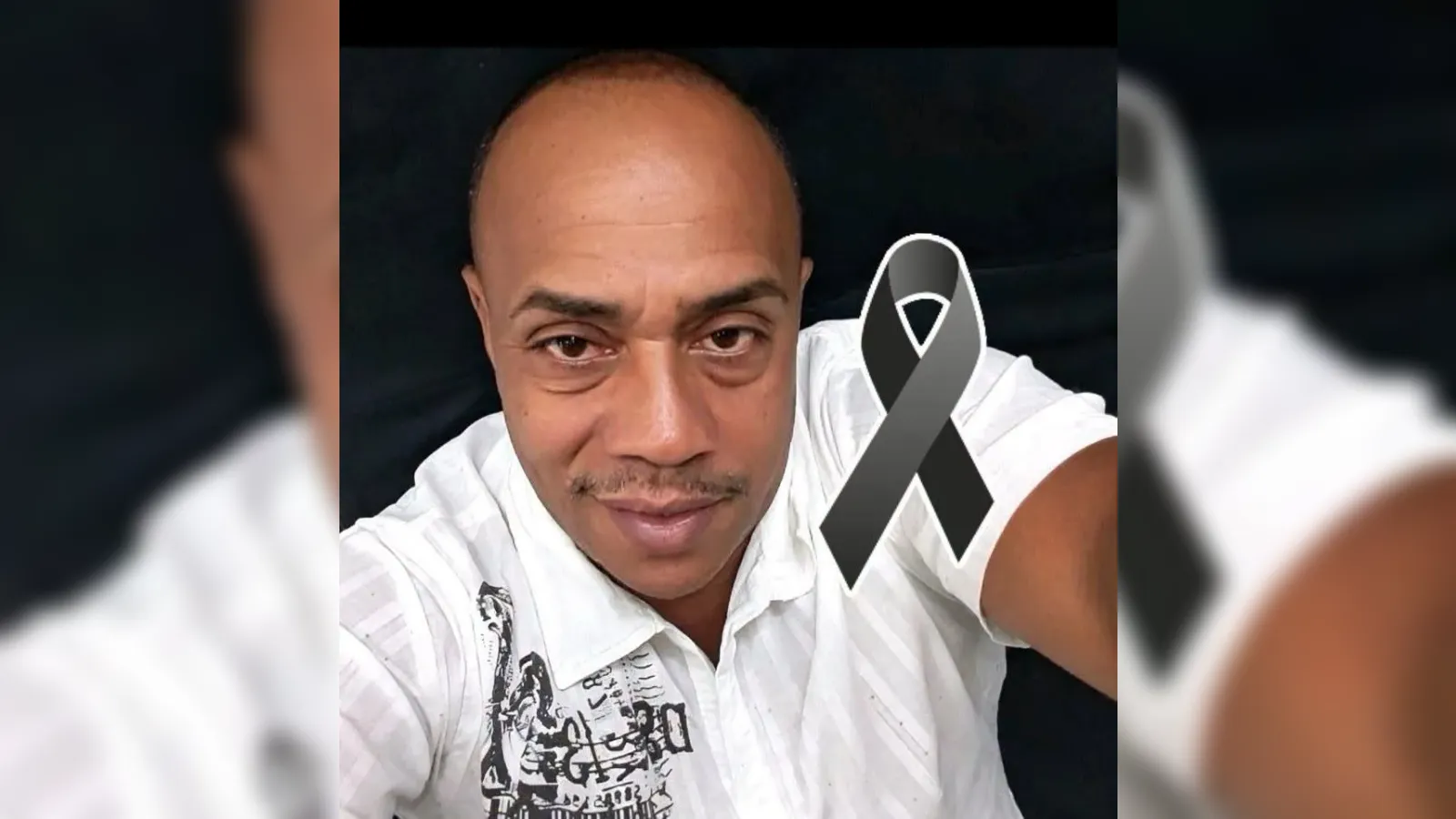 Selfie of a man in a white shirt with a black mourning ribbon overlay, signaling mourning or tribute.