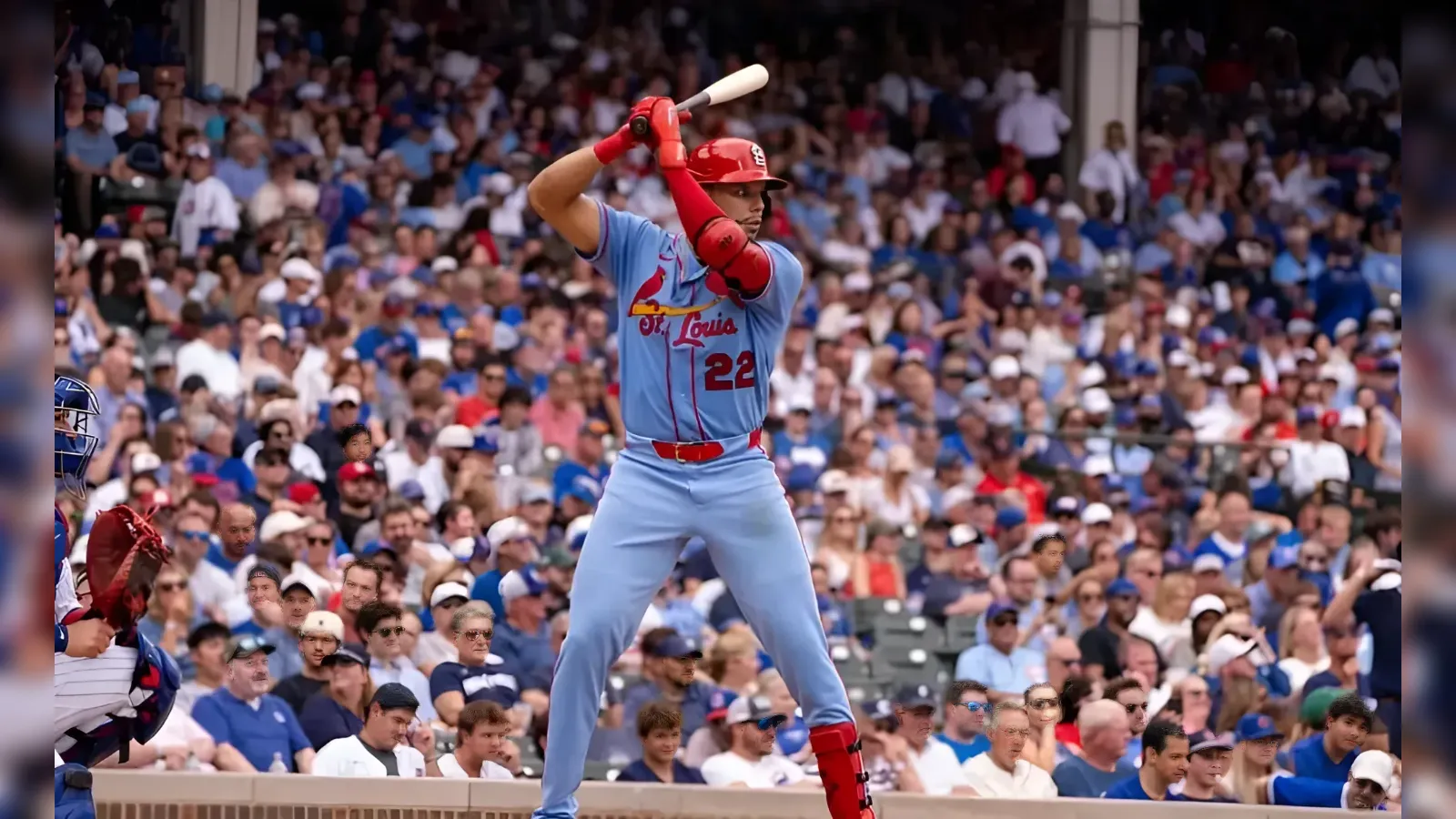 Baseball player in a light blue uniform swings at a pitch, crowd in the stands behind him.