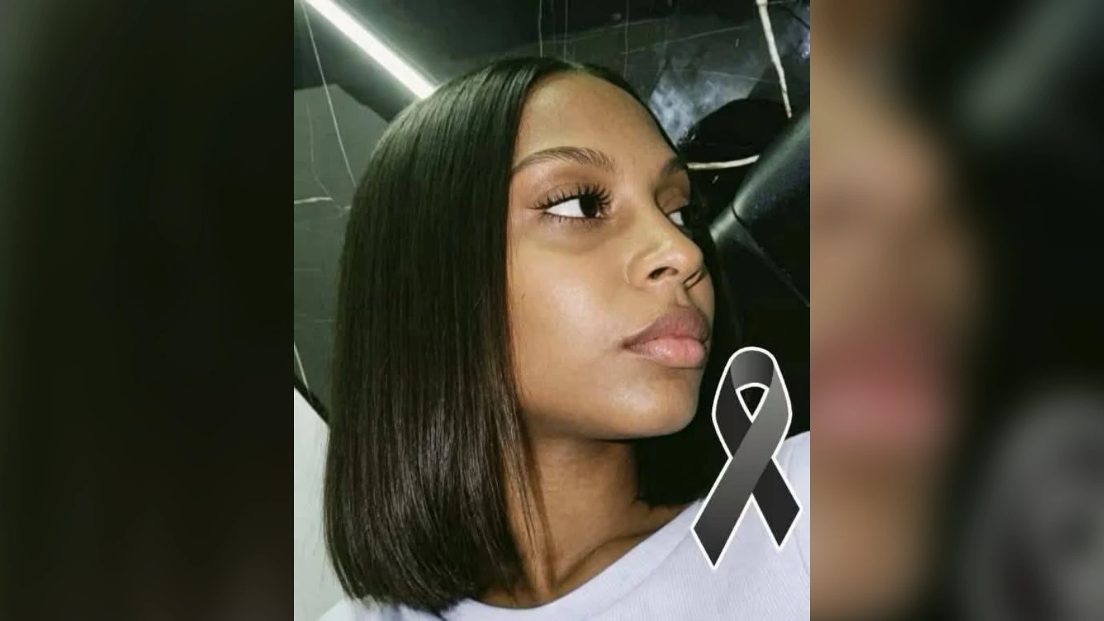 Portrait of a woman with straight black hair and a gray awareness ribbon, signaling support for an awareness cause.